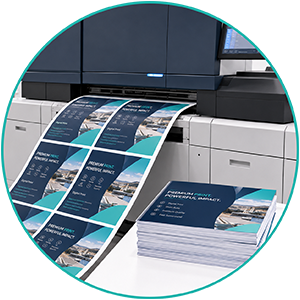 Professional digital print production with printed sheets and finished print materials at Print-Tag